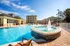 Hot tub with fountain, that is pouring into a large pool.