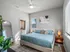 Elegant bedroom with king-sized bed, wall art, and natural lighting.
