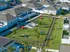 Aerial view of a charming community garden surrounded by modern residences.