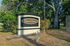 Inviting entrance sign of Doral Oaks Apartments surrounded by lush greenery.