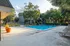 Inviting outdoor pool area with lounge chairs and lush greenery.