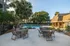 Inviting outdoor pool area surrounded by lush greenery and seating, perfect for relaxation.