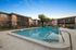 Inviting swimming pool in a tranquil apartment complex with modern two-story buildings.