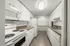 Bright and stylish galley kitchen with white cabinetry, sleek countertops, and modern appliances.