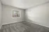 Bright and airy bedroom with plush carpet and large window with blinds, offering natural light and serene views.