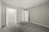 Inviting bedroom with plush carpeting and a walk-in closet.