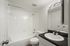 Bright and modern bathroom featuring a sleek white bathtub, polished sink, and a large mirror.