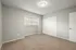 Inviting bedroom with soft carpet flooring, large window, and closet.