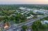 Aerial view of a lush residential area surrounded by greenery and modern buildings.