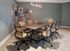 Contemporary meeting room with a sleek table, modern chairs, and artistic wall decor.