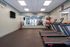 Modern fitness room with treadmills, free weights, and exercise balls, designed for an energetic workout.