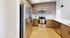 Modern kitchen with stainless steel appliances, sleek wooden cabinets, and elegant lighting.