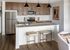 Modern kitchen with sleek wooden cabinets, stainless steel appliances, and a stylish breakfast bar.