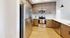 Modern kitchen with stainless steel appliances, sleek wooden cabinetry, and elegant lighting.