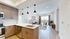 Bright open-concept kitchen and living area with modern fixtures and expansive windows.