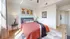 Bright and inviting bedroom with modern decor, large window, and warm color palette.