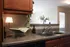 Cozy kitchen nook with elegant granite countertops, a chic double sink, and ambient lighting, providing a warm and inviting atmosphere.