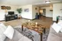 Inviting living room with elegant furnishings and open space, featuring a cozy seating area and a stylish home office nook.