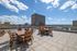 Expansive rooftop terrace with stylish outdoor seating, offering panoramic city views and a perfect space for relaxation.