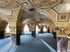 Stunning ornate interior featuring richly decorated ceilings and elegant archways, offering a luxurious and historical ambiance.