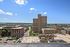 Breathtaking city view showcasing modern high-rises under a brilliant blue sky, perfect for urban living.