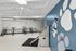 Innovative apartment amenity featuring a modern bike storage area with colorful wall hooks and a sleek pet washing station.