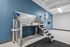 Modern pet grooming station with ramp, against a stylish blue wall with decorative paw prints.
