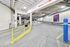 Spacious and well-lit indoor parking area with clear exit signage and secure storage facilities at the Treasury.