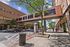 Vibrant urban scene with pedestrian-friendly walkway and modern architecture on a sunny day.