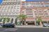 Historic urban building facade with sunlit windows and charming street view at The Treasury.