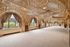 Luxurious hall with ornate arched windows, intricate ceiling designs, and elegant drapery, perfect for sophisticated events.