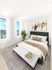Bright and modern bedroom with elegant decor, featuring a luxurious bed, chic artwork, and expansive windows showcasing a stunning city view.