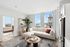 Elegant urban apartment with a bright living room, modern decor, and stunning city views through large windows.