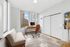 Bright and modern home office with large windows offering stunning city views, featuring a sleek desk, ergonomic chair, and minimalist decor.