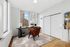 Bright home office with modern decor, featuring a stylish chair, sleek desk, and large windows with cityscape views.
