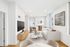 Elegant modern living room with sleek furnishings, large windows, and a stylish marble coffee table.