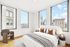 Bright and inviting bedroom with three large windows offering stunning city views, featuring a cozy upholstered bed and stylish decor.