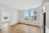 Bright and modern apartment with sleek hardwood floors, large windows offering breathtaking cityscape views, and a stylish kitchen with stainless steel appliances.