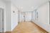 Bright, spacious room with hardwood floors and large windows offering ample natural light.