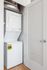 Modern apartment laundry area with sleek, energy-efficient stacked washer and dryer in a compact, stylish closet.