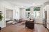Chic urban apartment with a cozy living area, modern kitchen, and large windows offering stunning architectural views.
