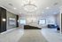 Elegant apartment lobby featuring a modern chandelier, marble floor tiles, and a stylish reception desk.