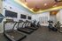 Modern fitness center with state-of-the-art treadmills, ellipticals, and bikes, perfect for an invigorating workout experience.