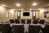 Elegant private cinema room with plush seating, modern lighting, and a large flat-screen TV, perfect for a luxurious movie experience.