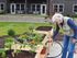 Charming apartment community garden with vibrant flowers and raised planters, showcasing peaceful living and outdoor spaces.