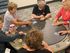 Engaging social scene with a group of friends enjoying a lively card game around a stylish poker table.