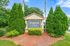 Charming entrance sign for Forest Vale Apartment Homes surrounded by lush greenery and blue skies.