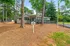 Inviting leasing office amidst lush greenery, featuring a charming porch and welcoming entrance.
