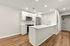 Sleek modern kitchen with stainless steel appliances, elegant white cabinetry, and a spacious island, perfect for contemporary living.