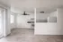 updated kitchen, dining and living space with vinyl plank flooring, new black fixtures, and sliding glass door